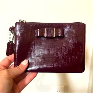 COACH burgundy wristlet with bow